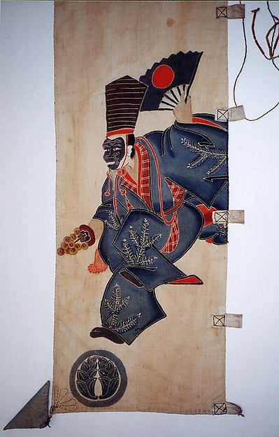 A masked figure in a dark robe steps across the light cloth, raising an open fan. Fine white lines articulate the robe and its plant designs; red accents sharpen the movement. A round dark device sits below the figure at the left.