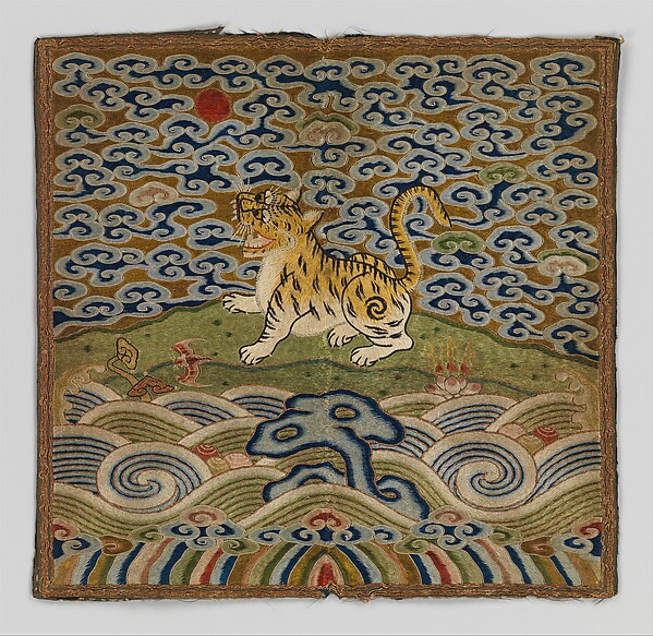 A tiger stands among stylized clouds and waves on a square embroidered rank badge, with a red circular sun near the upper left.